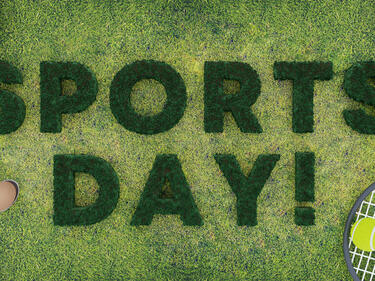 "Sports Day" in green on grass