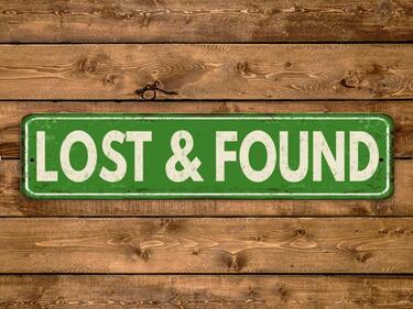 "Lost and Found" sign on wooden background