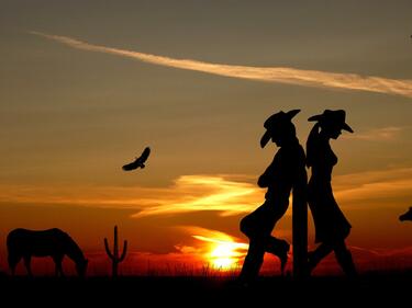 silhouette of cowboy/cowgirl sunset