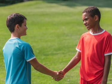 two students shaking hands