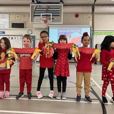 Elementary students showing their dragon art.